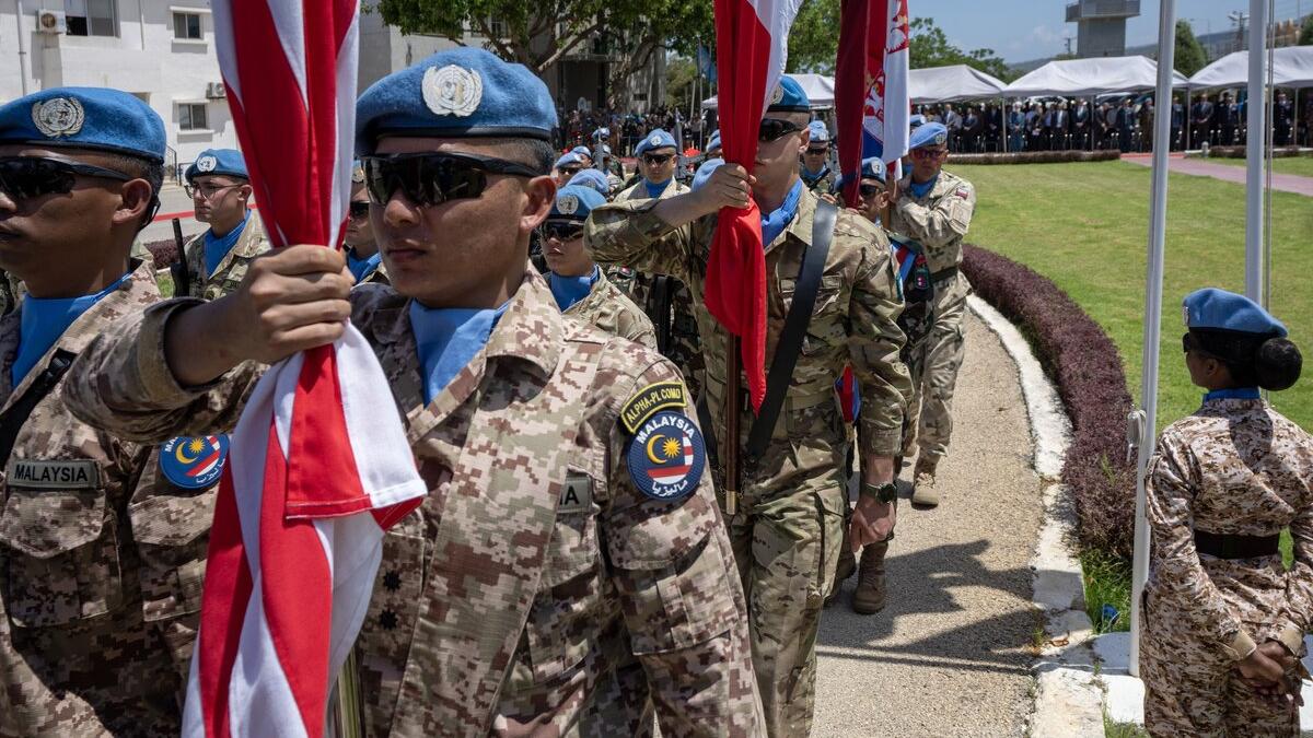 Peacekeepers march outside.