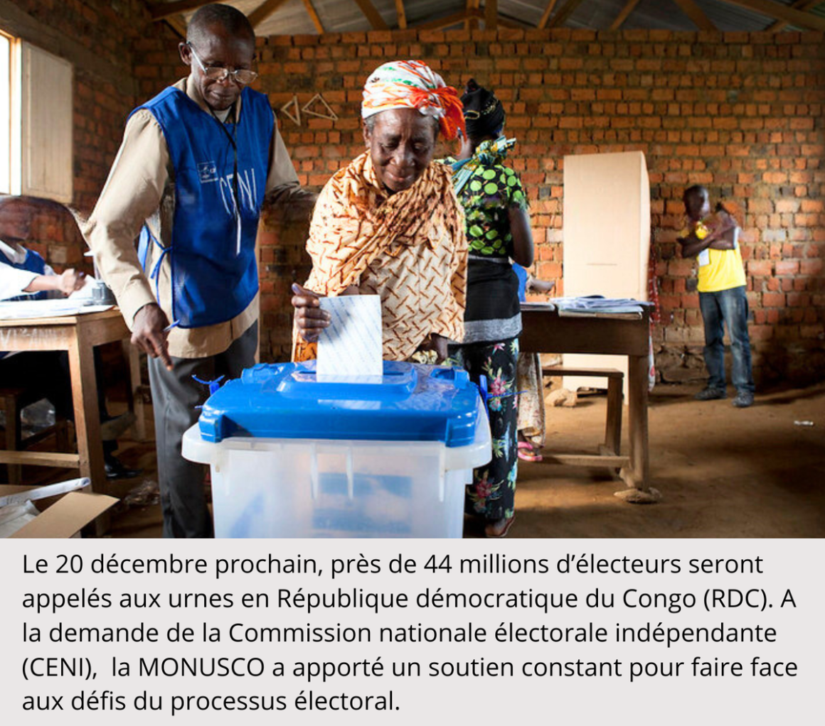 A woman placing a vote in a ballot box.